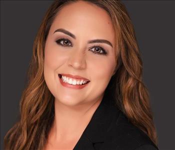 female-employee-with-long-brown-hair-black-background